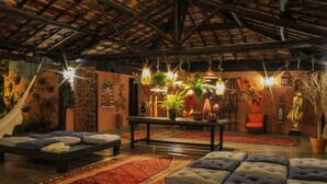 A cozy room with a bed, a sofa, and a table with plants.