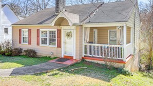 A single-story house with a front porch, a chimney, and a small front yard. - 5 Mi to Dtwn ATL! Family Home w/ Veranda & Yard (Atlanta)
