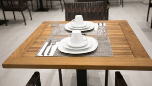 A dining table set with white plates, a cup, and cutlery. - Tropea Luxury & Charm (Tropea)