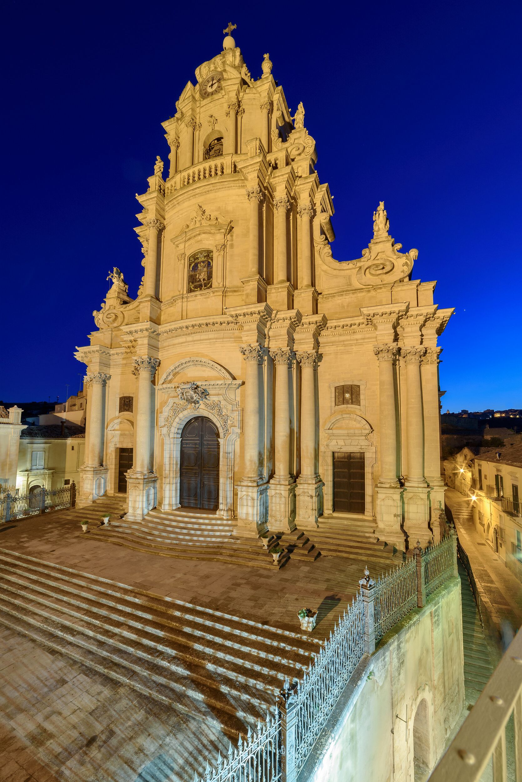 A grand cathedral with a large central doorway, ornate columns, and a bell tower.