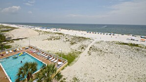 A beach resort with a swimming pool, sun loungers, and a view of the ocean. - Relax and Catch a couple fish! Drop all your worries it's vacation time. 🕮🏖️ (Gulf Shores)