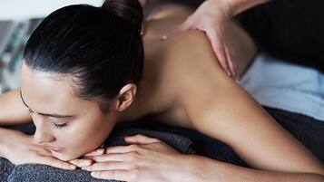 A person receiving a back massage.
