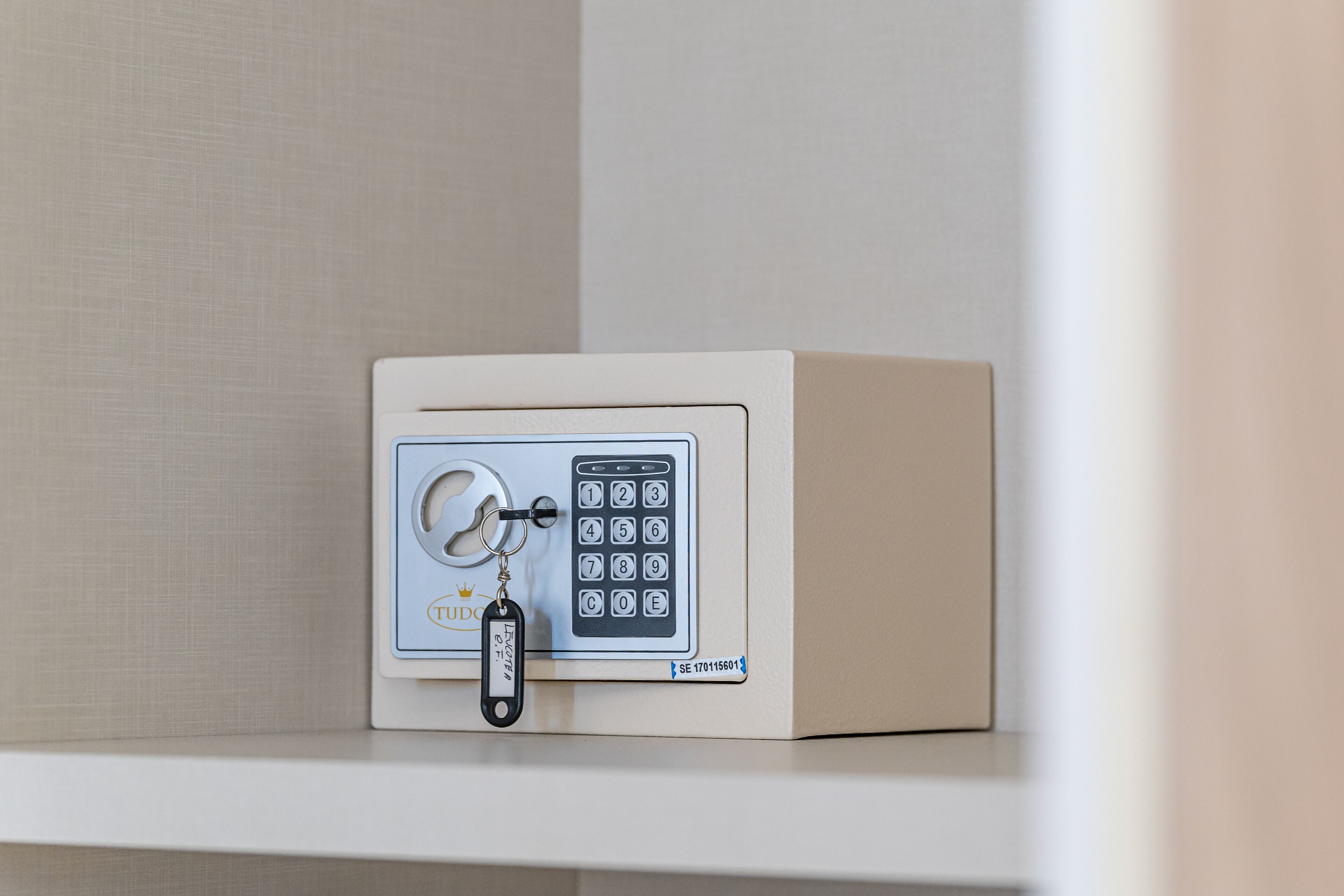 A safe with a keypad and a keyring.