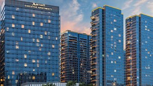 Um edifício de Marriott Executive Apartments com várias estruturas altas, janelas amplas e varandas.