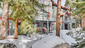 A two-story house with a balcony, surrounded by snow-covered ground and trees. - Pinecreek #F - 3 BR: Close to Town- Shuttle to Slopes- Pool & Hot Tub Access (Breckenridge)
