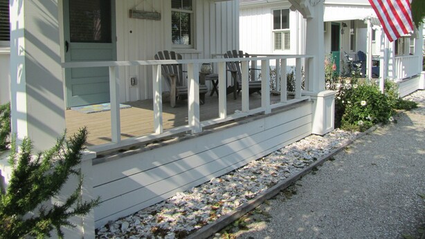 A white house with a porch, two Adirondack chairs, and an American flag. - Seabrook - On Turtle Time (Pacific Beach)