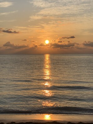 Experience the serene beauty of a coastal sunset with a tranquil sea view.