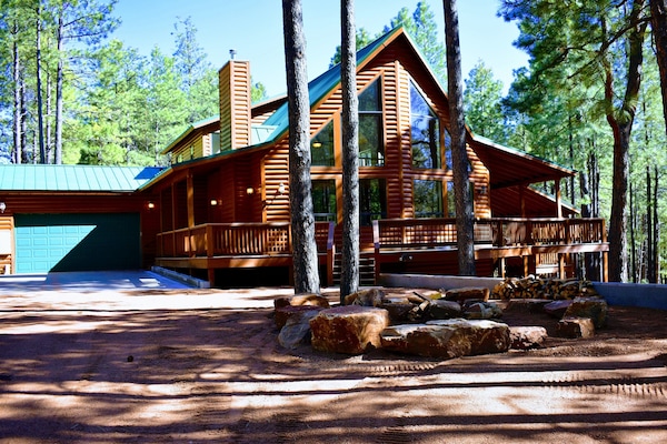 Front view with ample parking, large garage and fireplace.