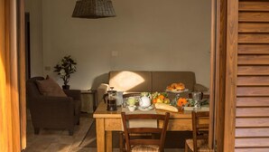 A dining area with a table set for breakfast, including croissants, fruit, and coffee. - Agritiurismo San Carlo-Family apartment - 3 bedrooms with San Carlo Quadri pool (pomarance)