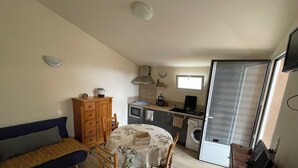 A compact living space with a kitchenette, a dining area, and a sofa. - house / villa - Monacia d'Aullène (Monacia-D'aullène)