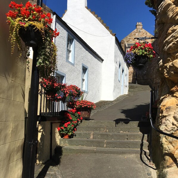 Stroll through historic streets lined with traditional buildings and charming flower baskets.