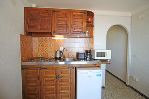 Fridge, microwave, coffee/tea maker, cookware/dishes/utensils