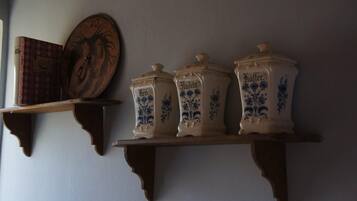 A shelf with three ceramic containers labeled 'Butter' and a book.