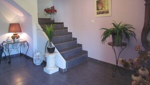 A staircase with a potted plant on the landing, a lamp on a side table, and a framed picture on the wall. - Character house for 12 people, PRIVATE POOL (Lussas)