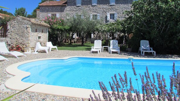A swimming pool with white lounge chairs and a stone building in the background. - Character house for 12 people, PRIVATE POOL (Lussas)