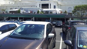 A hotel with a large parking lot filled with cars. The hotel has a prominent sign with the name 'Cures Marines'. - Studio in Trouville sur Mer (Trouville-sur-Mer)