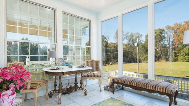 A sunlit room with a large window, a bench, a table with chairs, and a potted plant. - "Historical”Yellow TeaCup Cottage,Farm setting, horses &goats ,rest n relax  (Rockford)