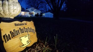 A wooden sign with a coffee cup illustration and the text "Welcome to The Yellow Tea Cup Cottage." - "Historical”Yellow TeaCup Cottage,Farm setting, horses &goats ,rest n relax  (Rockford)