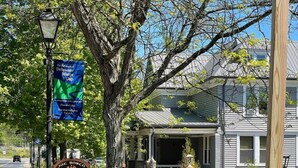 A street with a wooden fence, a BBQ sign, and a water gap banner. - Whitetail Retreat-Hiking, Biking & River adventure (East Stroudsburg)