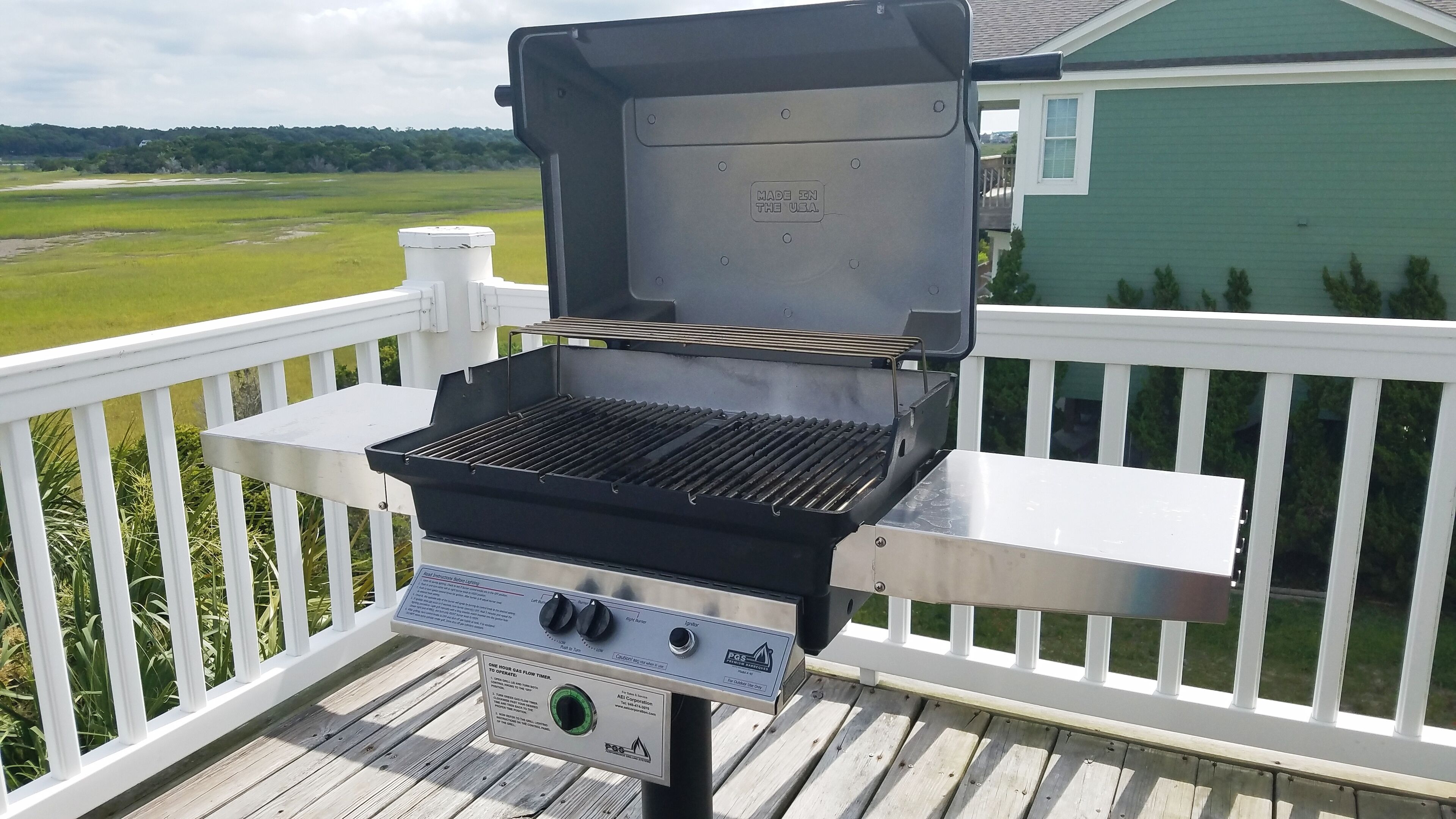 Upper back balcony has gas grill and seating to enjoy tranquil marsh and ICW.