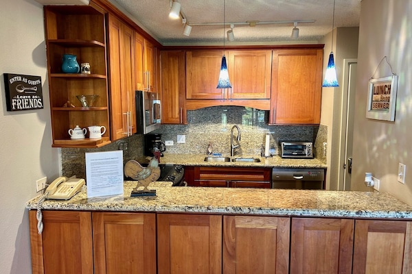 Remodeled kitchen with Cherry Wood Cabinets and Granite Counters