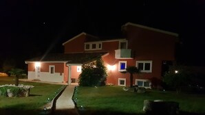 A two-story house with a well-maintained lawn and a pathway leading to the entrance. - Poreč Sunshine (Porec)