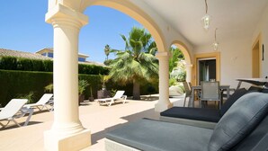 A covered outdoor seating area with lounge chairs, a dining table, and a sofa. - Wonderful private villa for 6 guests with private pool, WIFI, A/C, TV and terrace (Benissa)