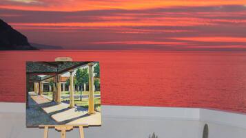 A painting of a courtyard with columns and a pathway, set against a backdrop of a sunset over a body of water.