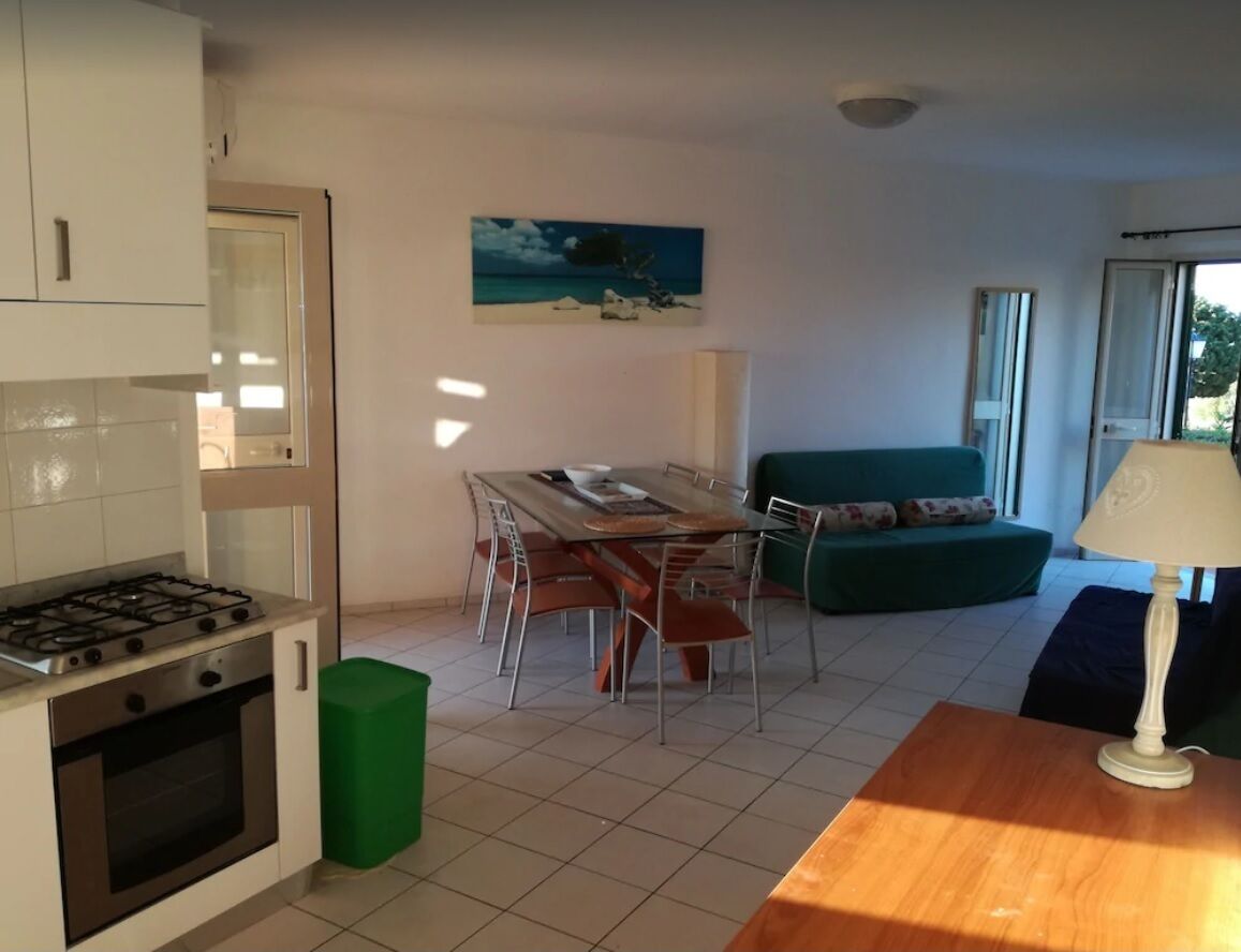 A compact living space with a kitchenette, dining area, and seating area.