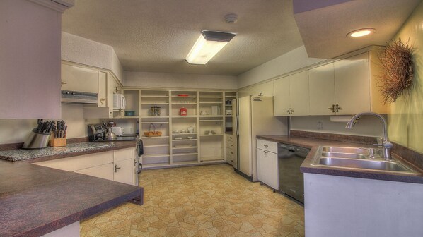 A compact kitchen with a built-in dishwasher, a sink, and a variety of storage cabinets. - The Racquetball House - Home to the BIGGEST hot tub in Killington!  (Killington)