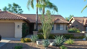 A residential house with a tiled roof, a garage, and a landscaped front yard with plants and rocks. - Scottsdale Escape - Close to Kierland All 5 star reviews !  Fall Savings! (Scottsdale)