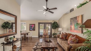 A spacious living room with a ceiling fan, a dining area with a table and chairs, and a large window. - Scottsdale Escape - Close to Kierland All 5 star reviews !  Fall Savings! (Scottsdale)
