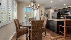 A modern kitchen with dark cabinetry, a stainless steel refrigerator, and a built-in oven. - Scottsdale Escape - Close to Kierland All 5 star reviews !  Fall Savings! (Scottsdale)