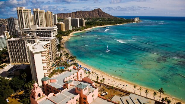 A coastal hotel with high-rise buildings, a beach, and a clear view of the ocean. - Direct Oceanfront in the Heart of Waikiki! Spectacular New Custom Reno! (Honolulu)