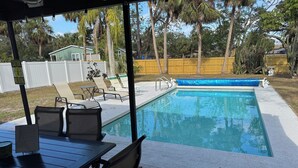 A covered outdoor swimming pool with lounge chairs and a table. -  4 Bed pool House by Bay!  Lido & Siesta Key Beaches very close  (Sarasota)