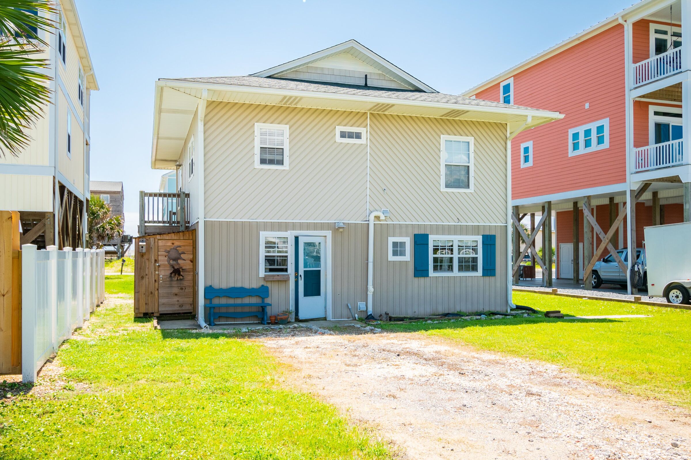 A two-story house with a front porch and a small attached garage.