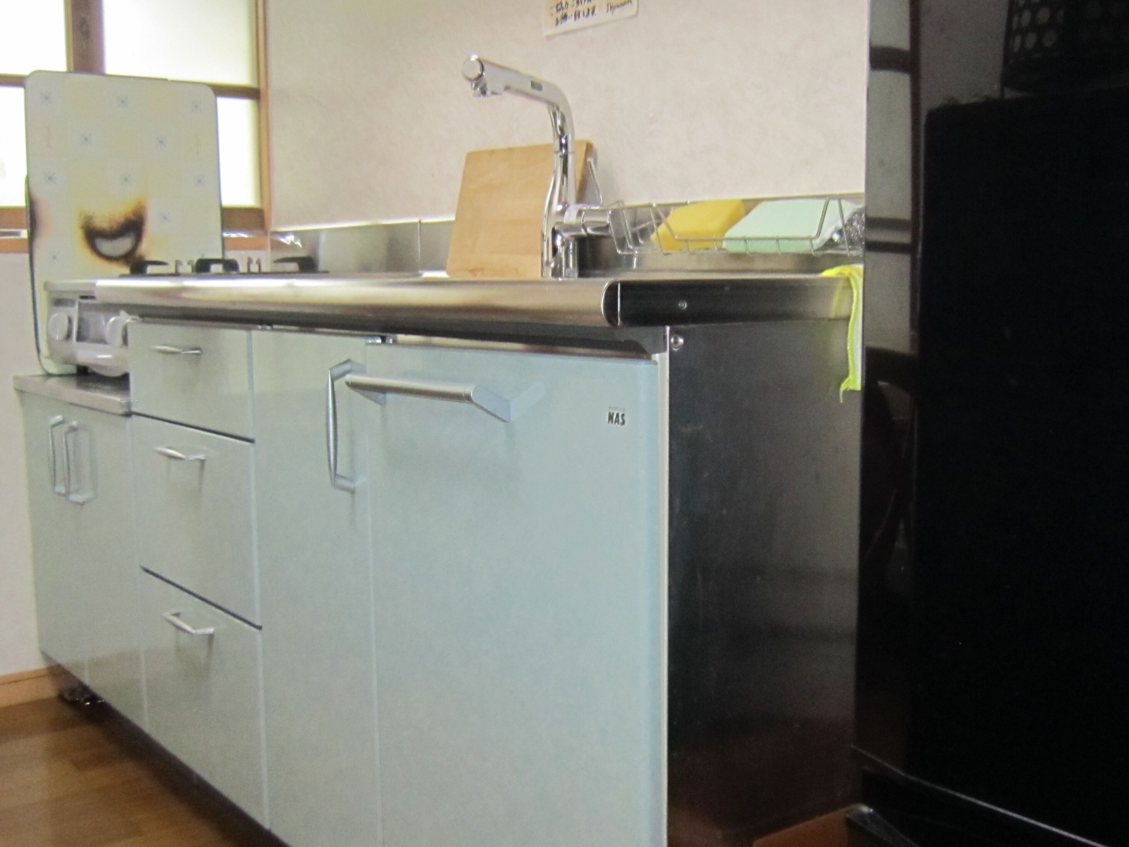 A kitchen with stainless steel appliances, a sink, and cabinets.