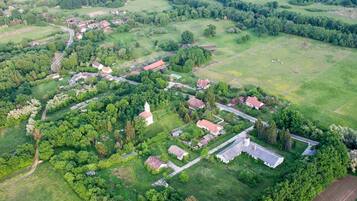 Surrounded by lush green fields and traditional buildings, this rural village offers a serene atmosphere.