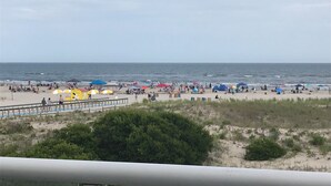 A beach with umbrellas and people. - Best Beachfront - Expansive OCEAN VIEWS Perfect location! 2 decks & large patio (Ocean City)