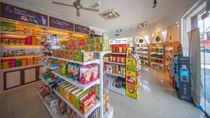 A well-lit grocery store with various food items and products on shelves. - Reunion Residence (George Town)