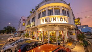 A building with a curved facade and the word "REUNION" prominently displayed. - Reunion Residence (George Town)
