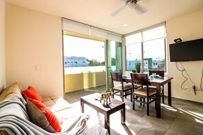 Apartment | Living area | 20-inch flat-screen TV with cable channels, TV - The Furlough Fur301 (Playa del Carmen)