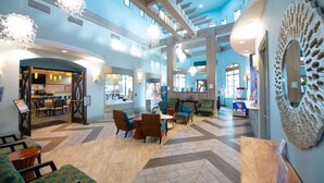 A spacious lobby with high ceilings, modern furniture, and a central seating area. - Luxury Championsgate Villa (Davenport)