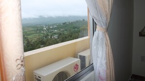 A balcony with air conditioning units and a view of a green landscape. - Memories Hotel (B'Lao)