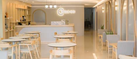 A modern Circle Inn reception area with a central desk, multiple seating arrangements, and a clean, polished floor.