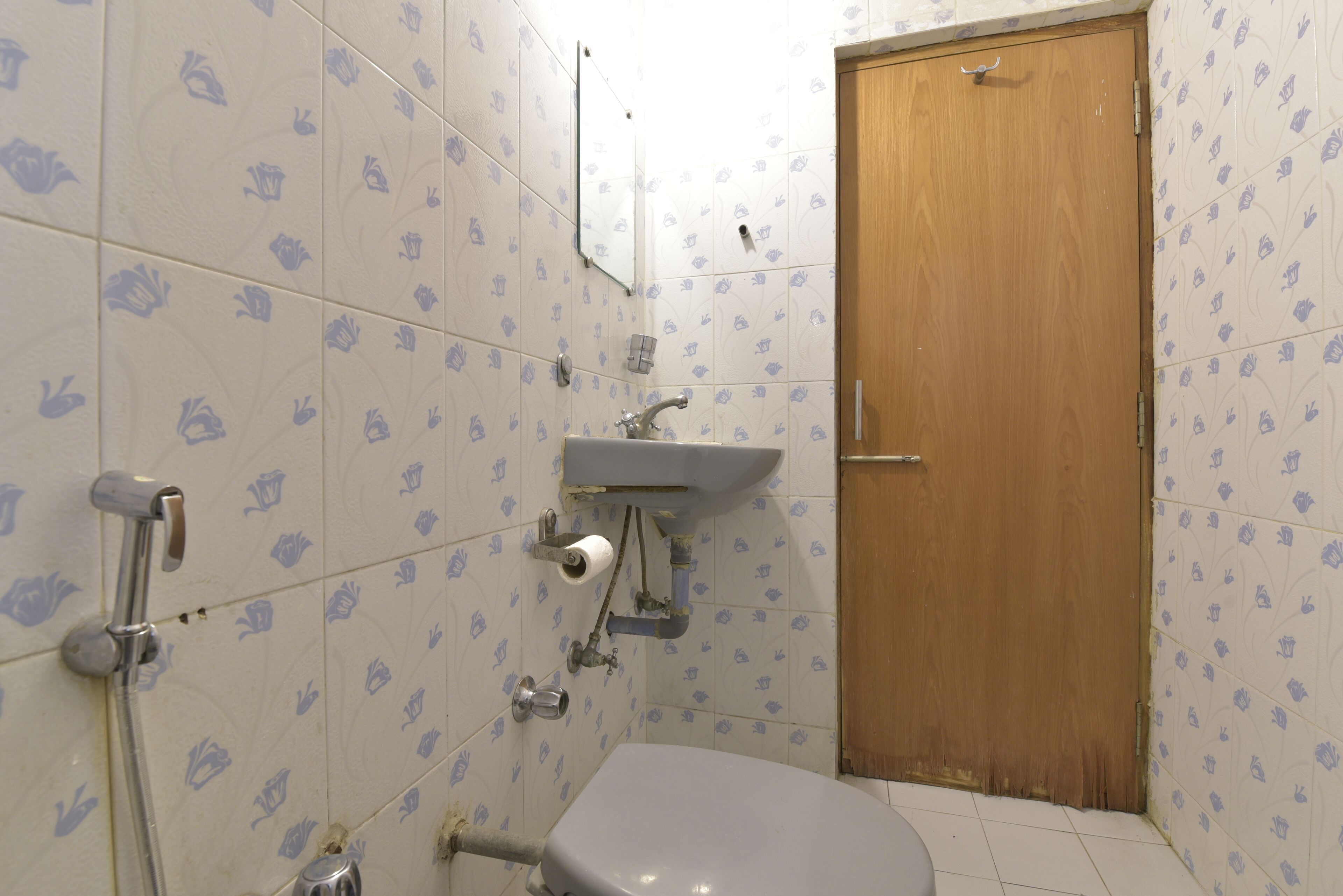 A bathroom with a toilet, sink, and shower.