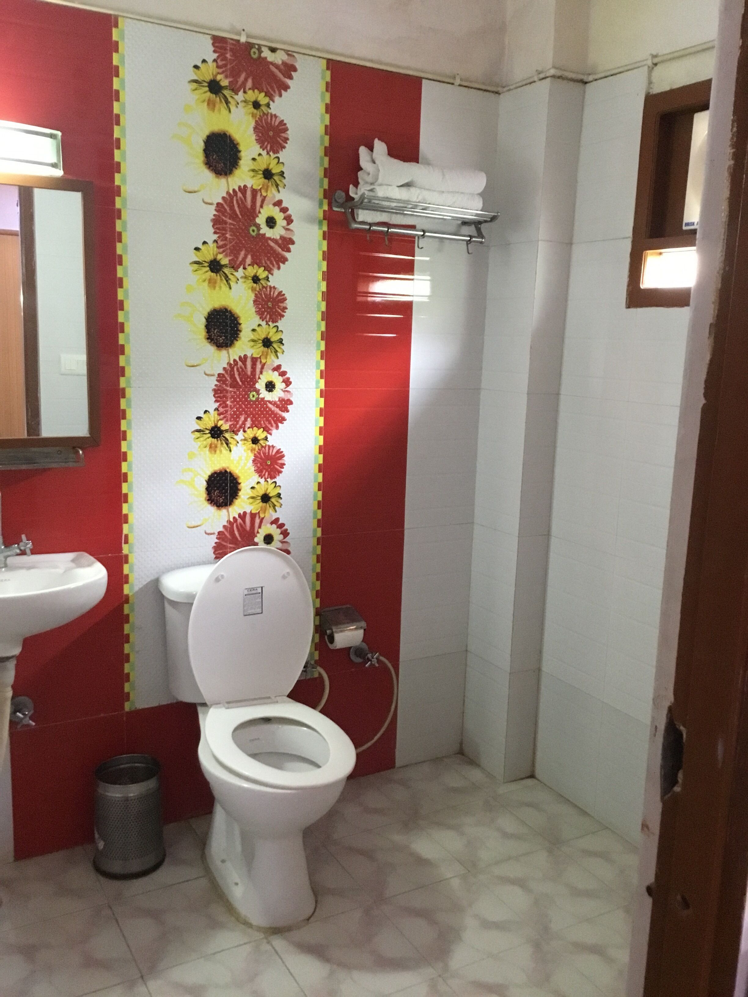 A bathroom with a toilet, sink, and a shower area.