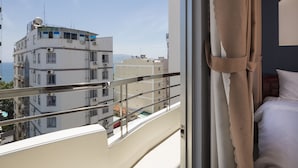 A balcony with a view of buildings and a clear sky. - Oressund Hotel (Nha Trang)