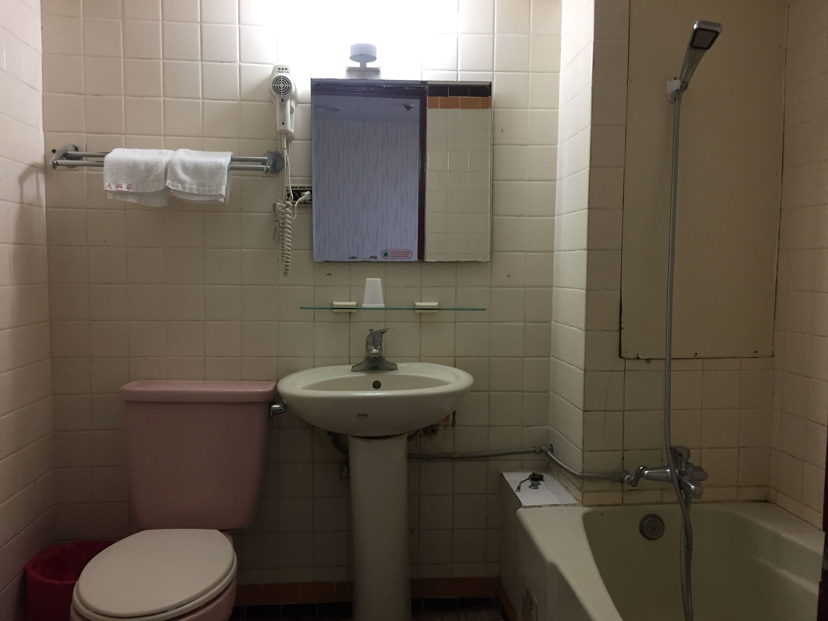 A bathroom with a toilet, sink, and bathtub.