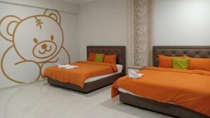 A hotel room with two beds, each with an orange bedspread and pillows, a large teddy bear mural on the wall, and a ceiling fan. - BB Villas - 5 min Jonker Melaka (Malacca City)